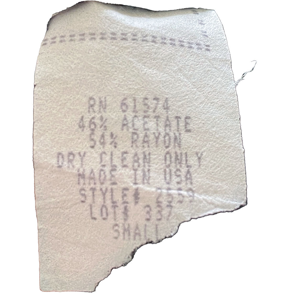 Distressed clothing tag from vintage pants.