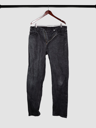 Vintage black denim Levi's 505 jeans on a hanger