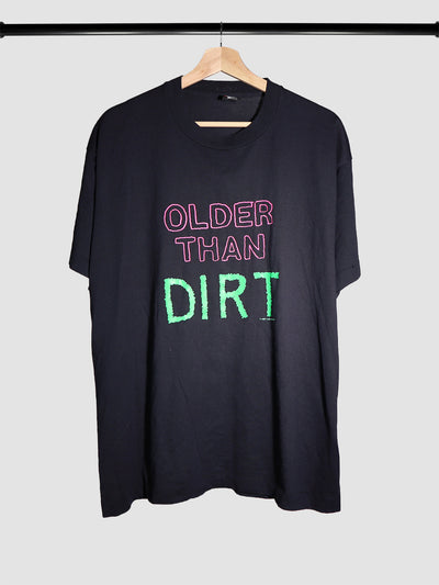 Vintage graphic t-shirt with pink and green text that says, "Older Than Dirt."