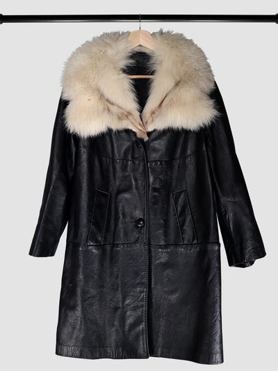 Vintage fur collar black leather coat hanging on a rack.